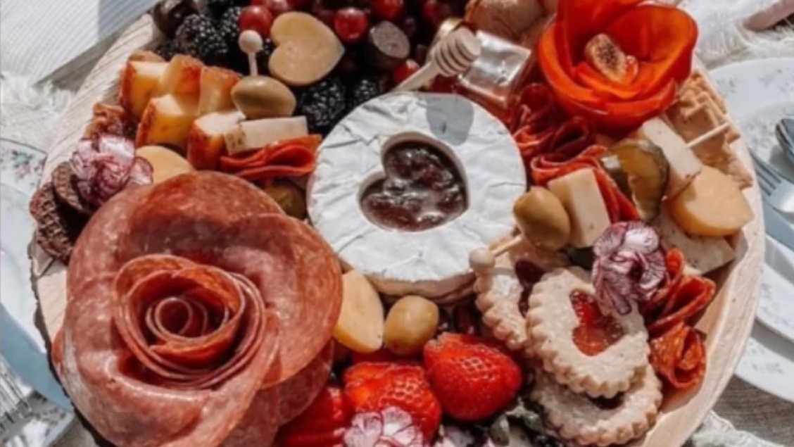 charcuterie board with meat, crackers and cheese
